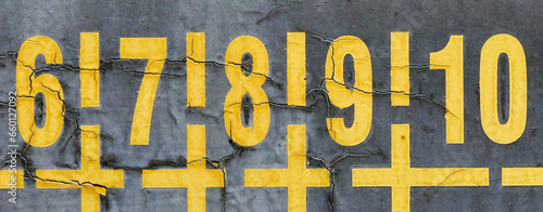 yellow numbers on old dirty wall