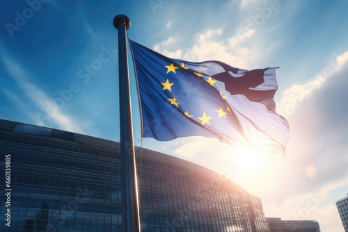EU flag waving in front of modern building with sunshine photo