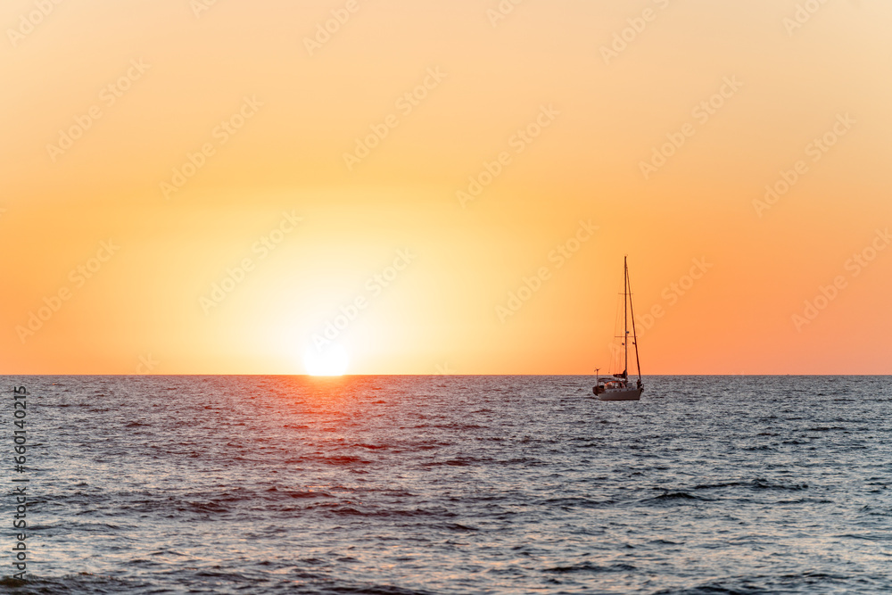 sailboat at sunset sailing on the sea - puerto vallarta mexico