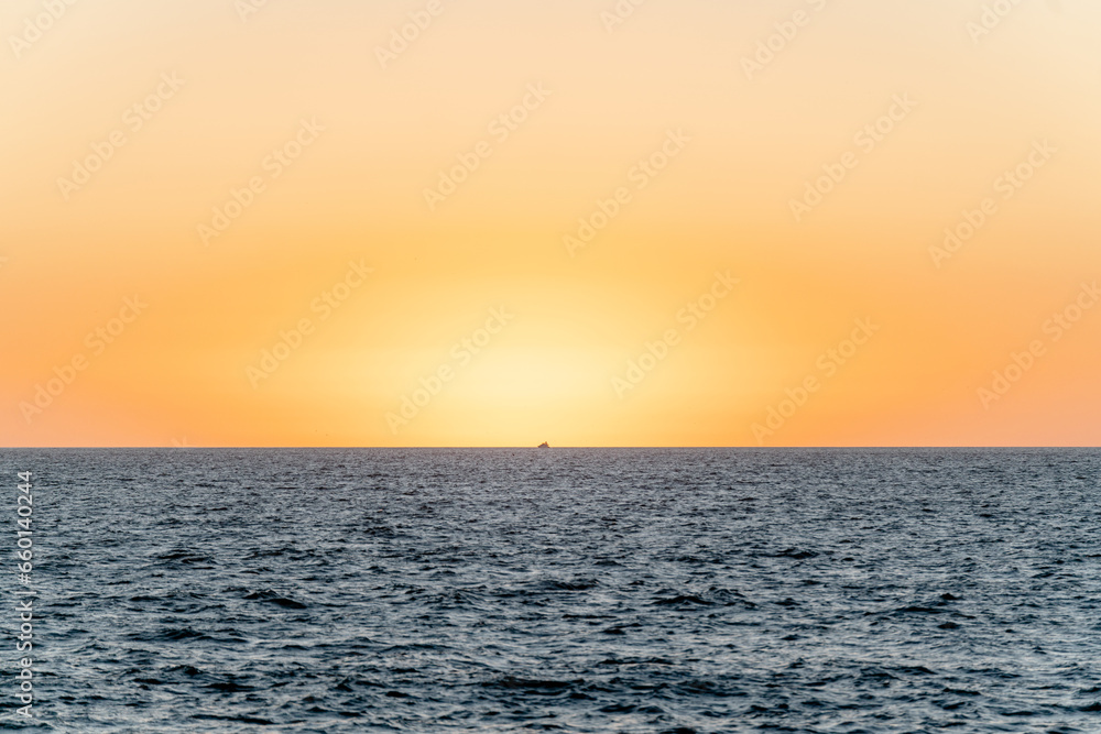 Fototapeta premium yacht at sunset sailing on the sea - puerto vallarta mexico