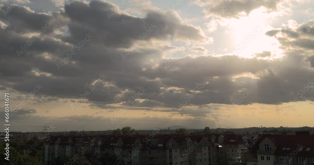 Sunlight breaking through clouds before sunset above the city Sunlight breaking through clouds before sunset above the city