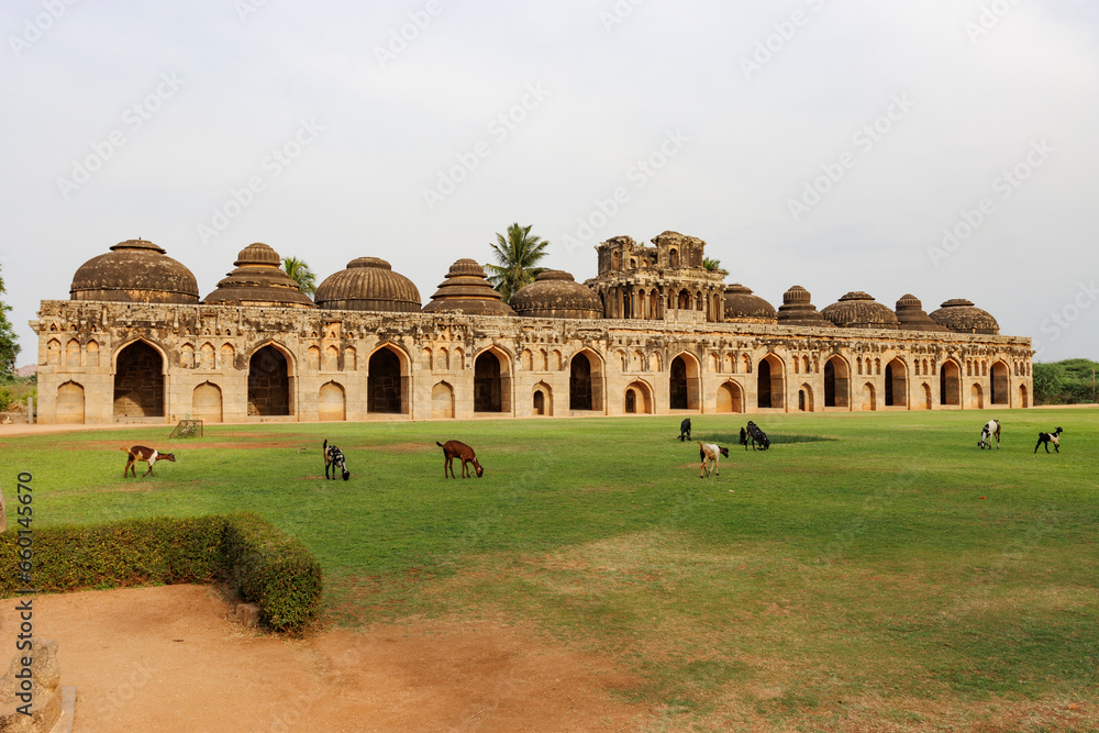 Herd with goats in front of the Elephant's Stables, stables for the royal elephants of the Vijayanagara Empire, in Hampi, Karnataka, India, Asia