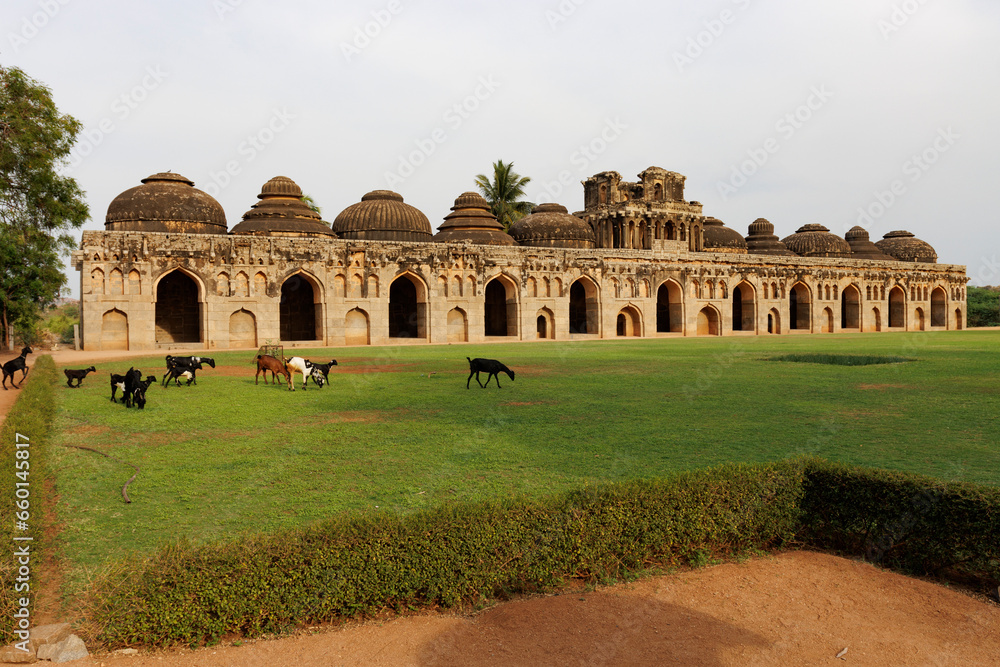 Herd with goats in front of the Elephant's Stables, stables for the royal elephants of the Vijayanagara Empire, in Hampi, Karnataka, India, Asia