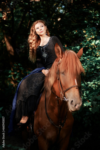 Portrait of young beautiful woman riding brown horse