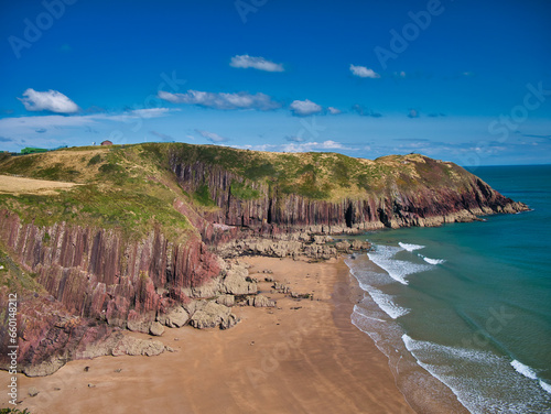 Canvas Print Coastal red cliffs near Manorbier in Pembrokeshire, Wales, UK - the vertically inclined rock strata of the bedrock is of the Milford Haven Group - Argillaceous rocks and sandstone, interbedded