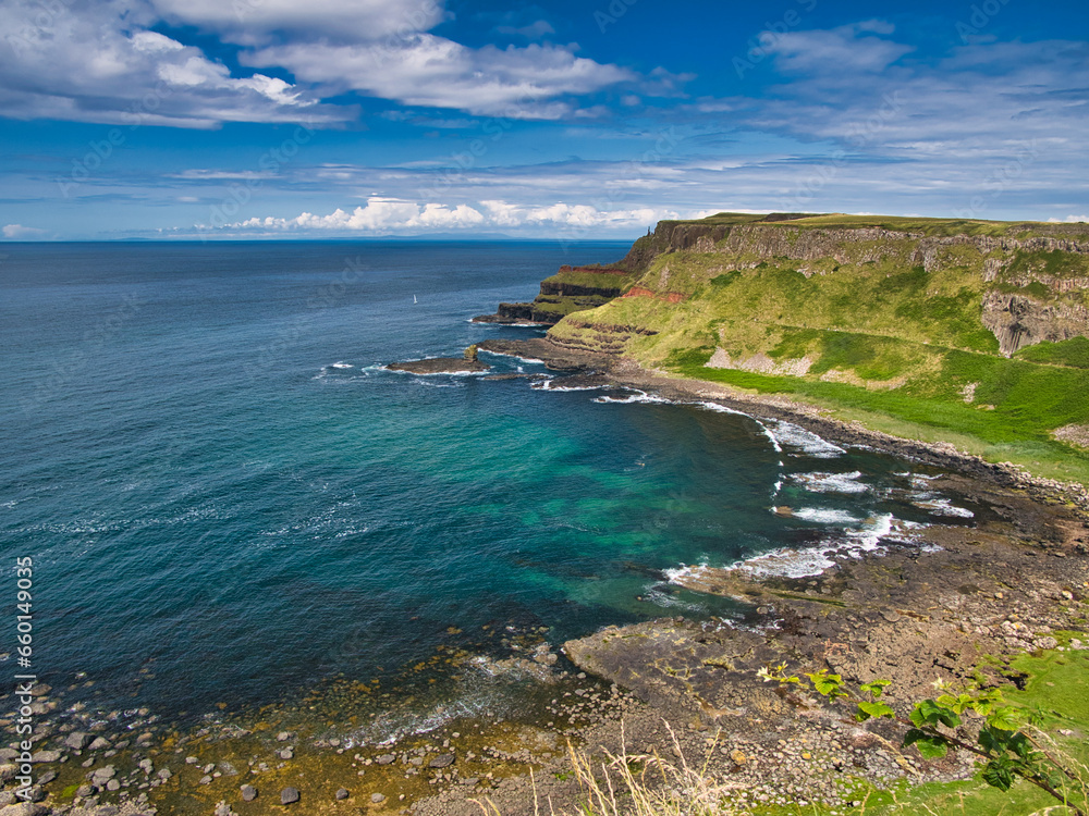 A sweep of coastal cliffs on the spectacular Antrim Coast in Northern Ireland, UK. Taken near Giant's Causeway on a sunny day in summer.