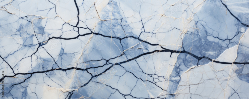 Closeup of mottled cracked marble with s in shades of blue, gray, and white. The cracks are thin and delicate, creating an intricate weblike pattern on the smooth surface of the marble.