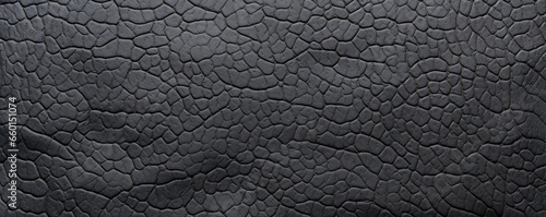 Closeup of creviced rubber texture This texture has a highly textured surface with deep crevices and fissures. The rubber material appears worn and weathered, with a dull, matte finish.