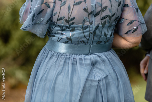Beautiful woman wearing blue lace dress, detail, back view