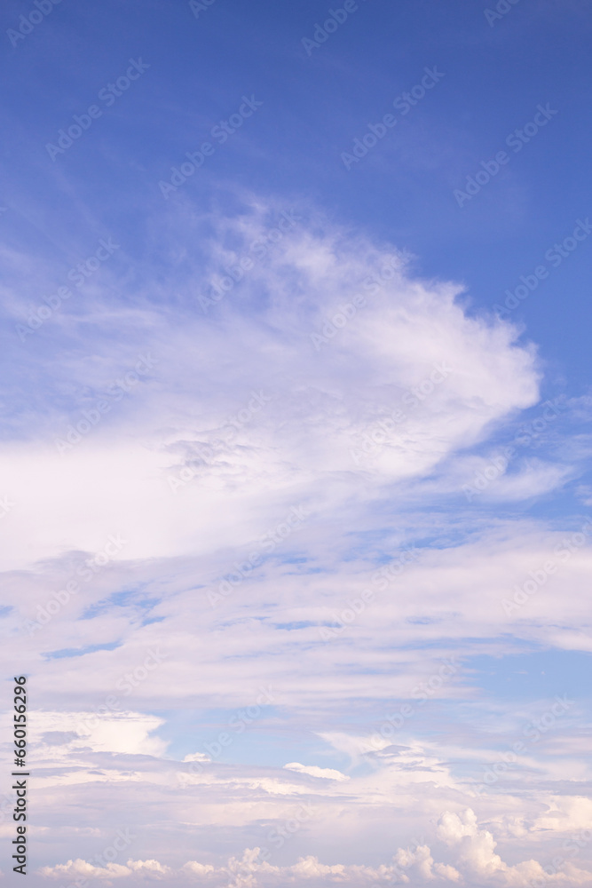 Beautiful soft gentle white cirrus clouds against blue cloudy sky, abstract background texture