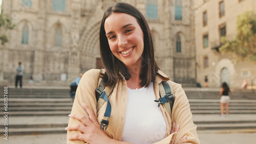 Photography Smiling traveler girl crosses her arms and looks at the camera with smile of an
