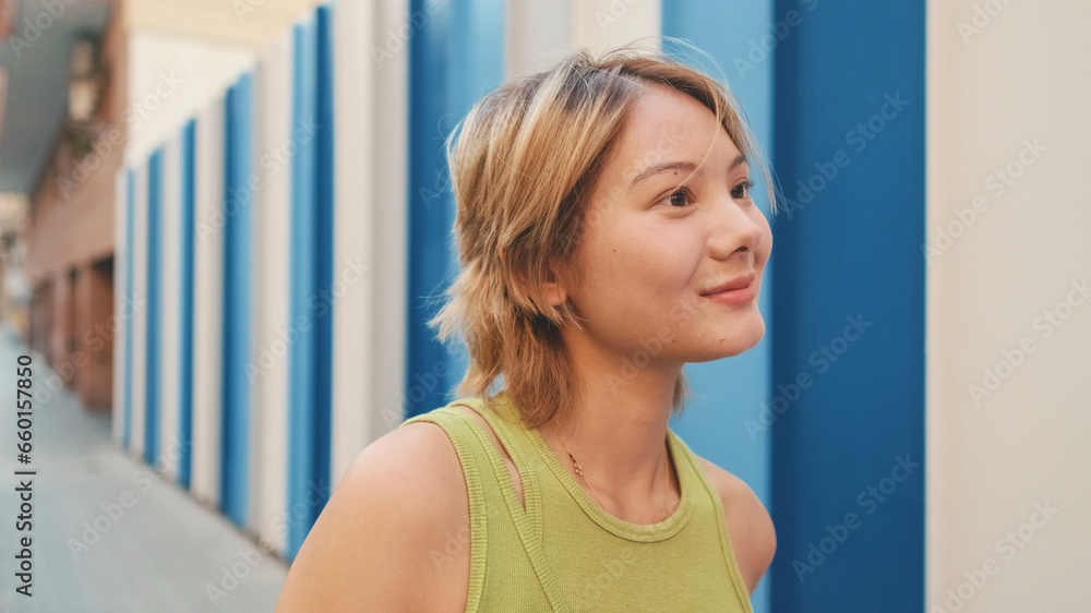 Close-up of girl listening carefully to someone and laughing