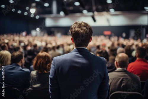 Speaker at Business convention and Presentation, rear view of participants in audience © thejokercze
