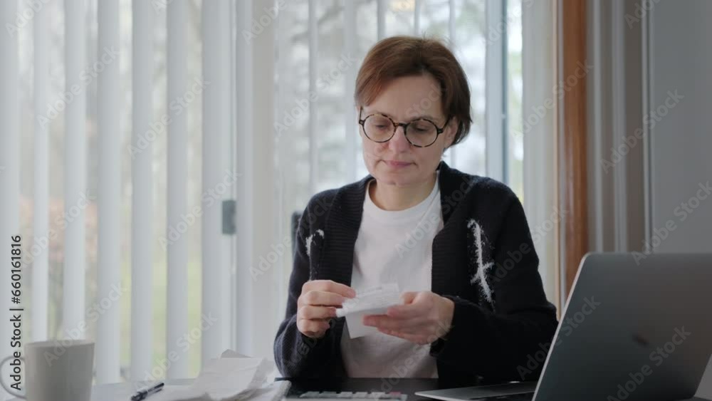 Woman sit at workplace desk feels frustrated concerned due high taxes, loan debt, dismissal, staff cuts notice. Day time Woman sit at workplace desk feels frustrated concerned due high taxes, loan debt, dismissal, staff cuts notice. Day time
