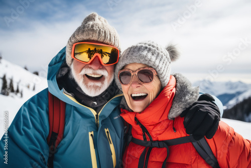 Active senior couple enjoying skiing in mountains, displaying joy, embodying a healthy, retired lifestyle. Happy retired couple on winter holidays