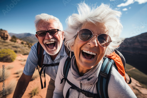 Active senior couple enjoying hiking and trekking in mountains, displaying joy, embodying a healthy, retired lifestyle. Happy retired couple