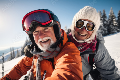 Candid capture of a joyful senior couple showing vitality while travel by snowmobile in the mountains on winter holidays. Active lifestyle in retirement