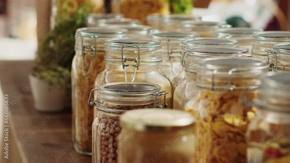 Close up on bulk products in recyclable glass containers used by zero waste supermarket to eliminate single use plastics. Local store pantry staples in sustainable packaging, zoom out shot Close up on bulk products in recyclable glass containers used by zero waste supermarket to eliminate single use plastics. Local store pantry staples in sustainable packaging, zoom out shot