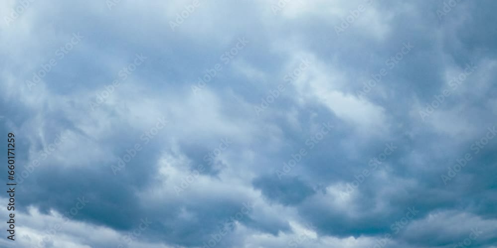 Fluffy grey clouds floating in the atmosphere. Overcast gloomy sky from low angle perspective. Fluffy grey clouds floating in the atmosphere. Overcast gloomy sky from low angle perspective.