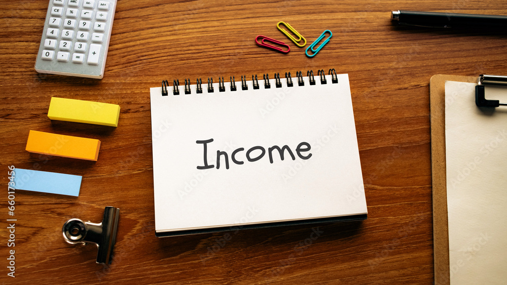 There is notebook with the word Income. It is as an eye-catching image. There is notebook with the word Income. It is as an eye-catching image.