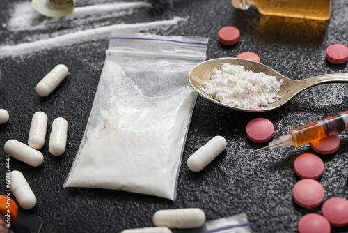 Photography Different drugs and syringe on dark background, closeup