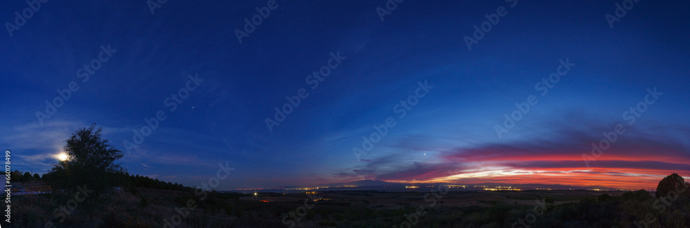 Panorama of evening twilight with colorful sky and Moon, Jupiter, Saturn and Venus over mountain landscape, Arguedas, Navarra, Spain