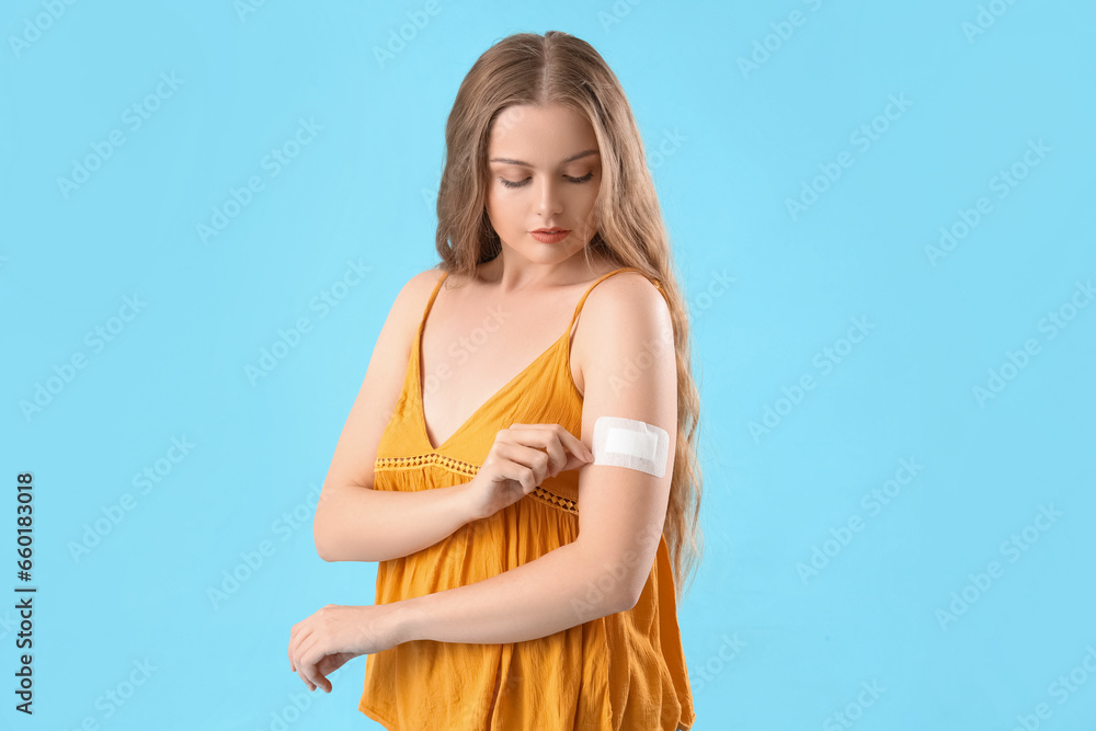 Young woman with applied contraceptive patch on blue background Young woman with applied contraceptive patch on blue background
