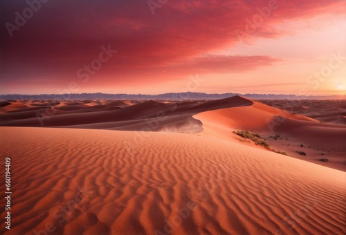 A vast desert landscape with rolling sand dunes under a crimson sunset