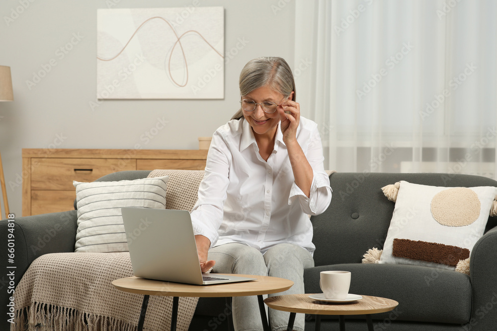 Beautiful senior woman using laptop at home Beautiful senior woman using laptop at home