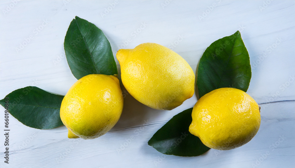 lemons with green leaves on white background top view 