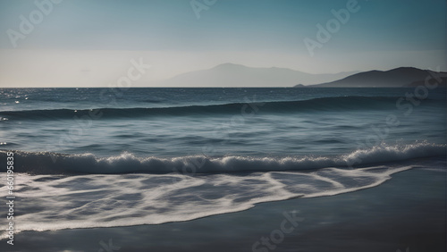 Beautiful seascape with waves and mountains in the background.