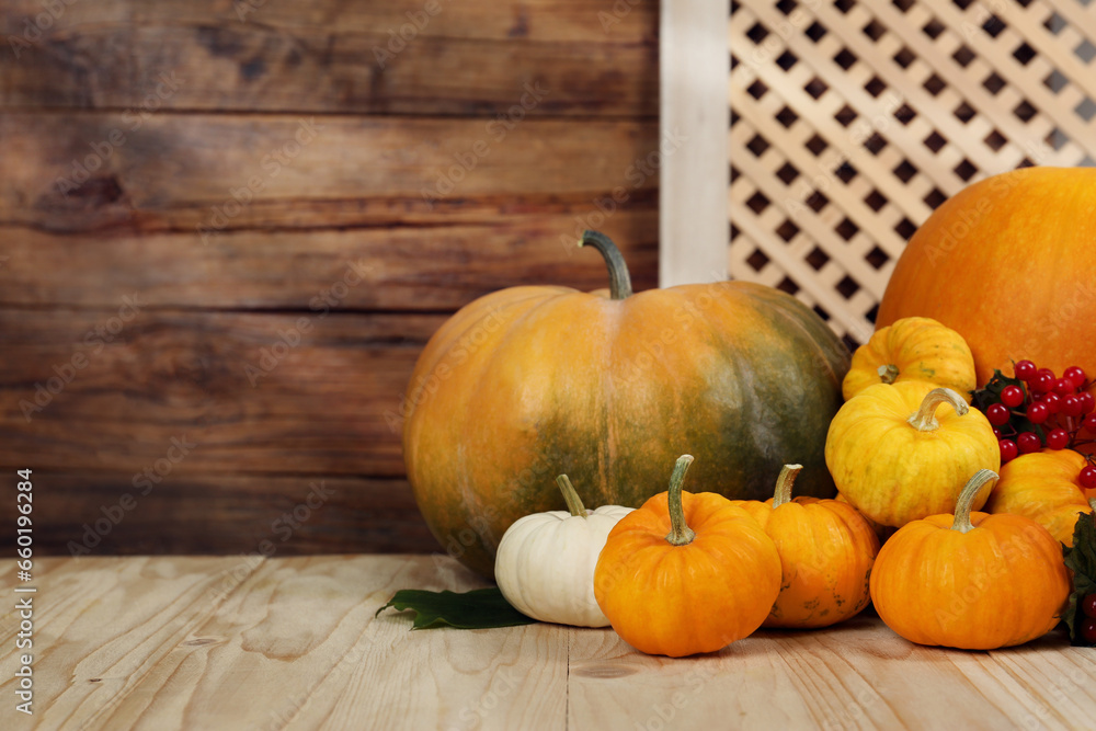 Happy Thanksgiving day. Pumpkins and berries on wooden table. Space for text Happy Thanksgiving day. Pumpkins and berries on wooden table. Space for text