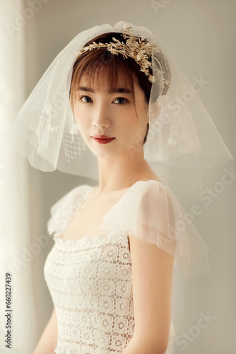 Asian bride wearing white wedding dress