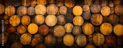 Stacked wooden barrels in a rustic setting photo