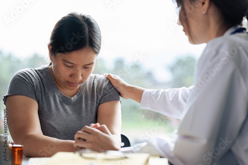 doctor therapist wearing white uniform with stethoscope touching frustrated patient shoulder
