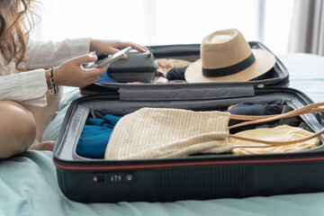 Woman packing suitcase on bed for a new journey packing list for travel planning preparing vacation Book Now Traveling Transportation
