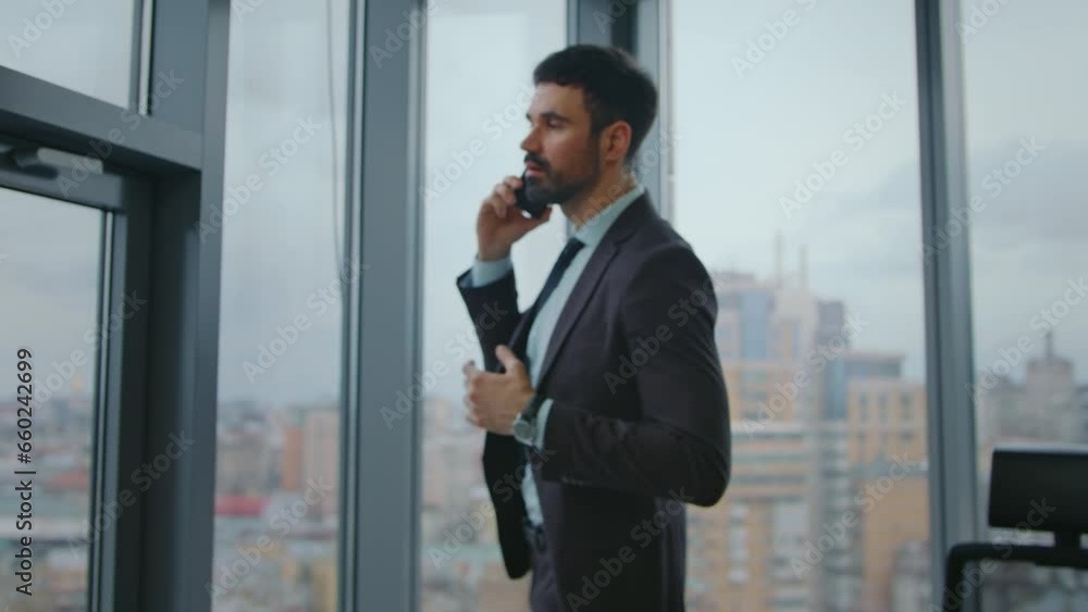 Business manager speaking cellphone looking at window office. Man calling phone. Business manager speaking cellphone looking at window office. Man calling phone.