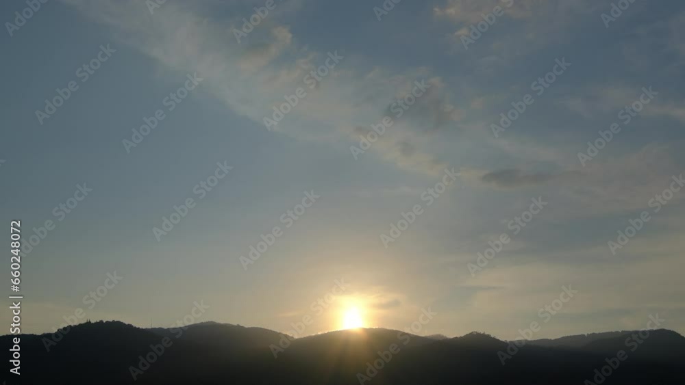Time lapse of the sun setting over hills that are covered with clouds. Time lapse of the sun setting over hills that are covered with clouds.