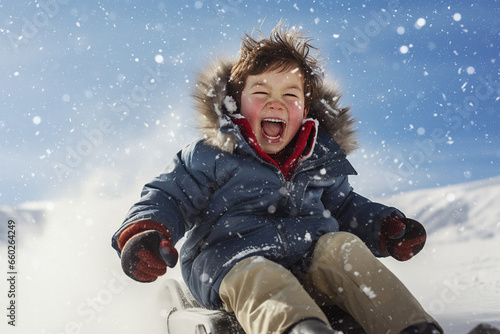 the boy rides down the hill on a sled