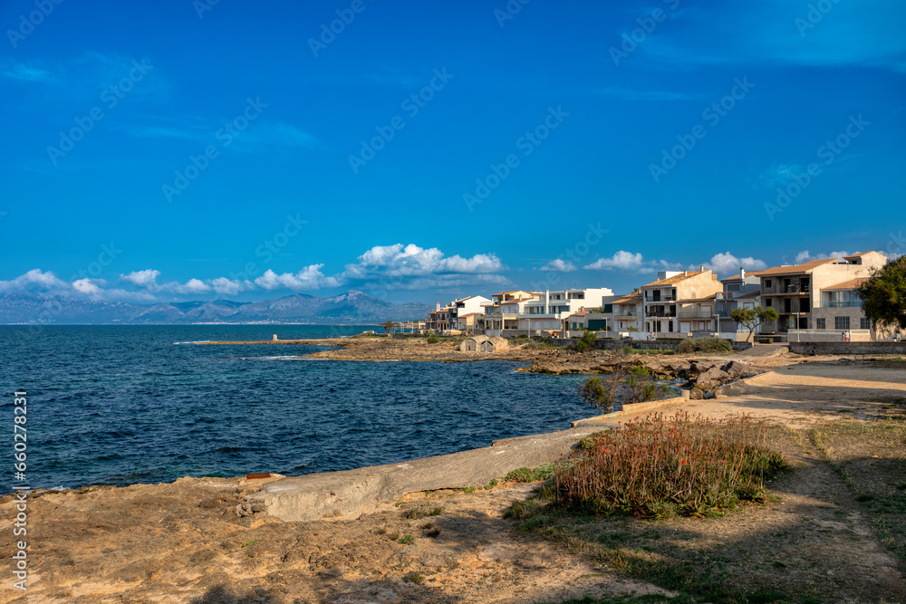 Sandy natural municipal beach in city Can Picafort .Sunny day, turquoise sea with sunset blue sky. Balearic Islands Mallorca Spain. Travel agency vacation concept.