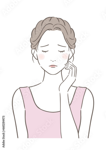 頬に手をあてて悩んでいる女性