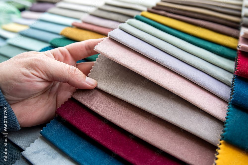 male hand points to perfect colored in fabric palette for renovation sofa or chair male hand points to perfect colored in fabric palette for renovation sofa or chair