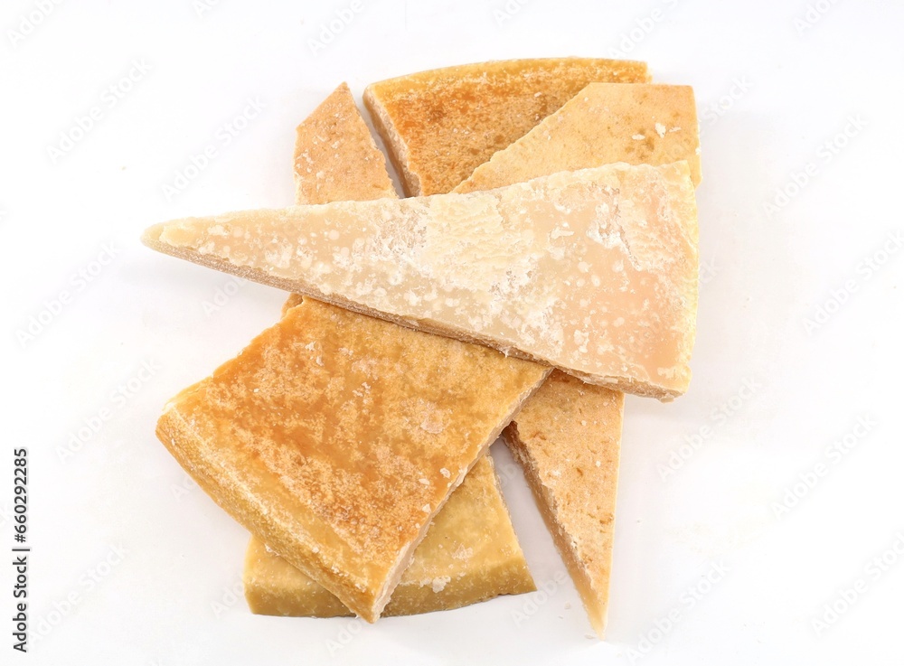 Large thick rinds of aged cheese on white background. Large thick rinds of aged cheese on white background.