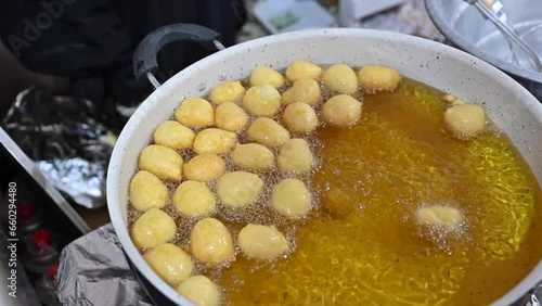 A traditional Arab sweet called Al Logimat (dumplings) is being prepared. photo