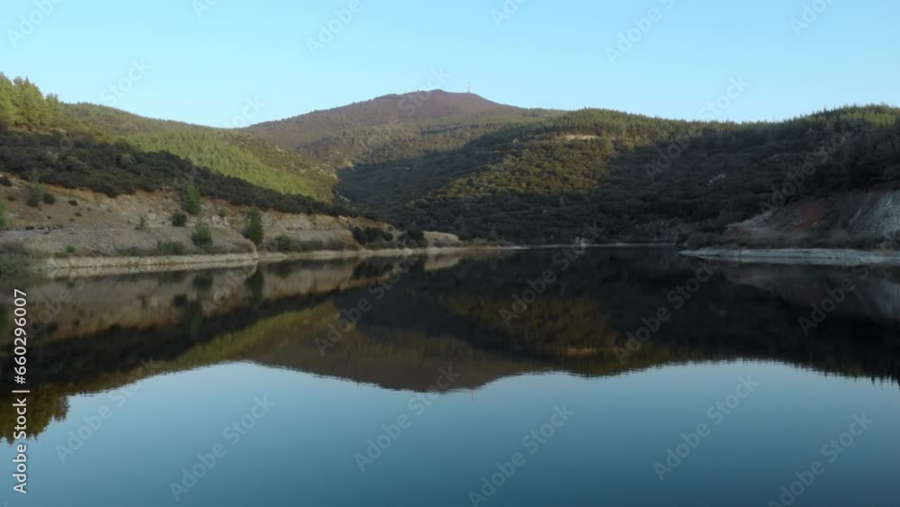 Aerial drone video over a mountain lake peak at distance blue background Aerial drone video over a mountain lake peak at distance blue background