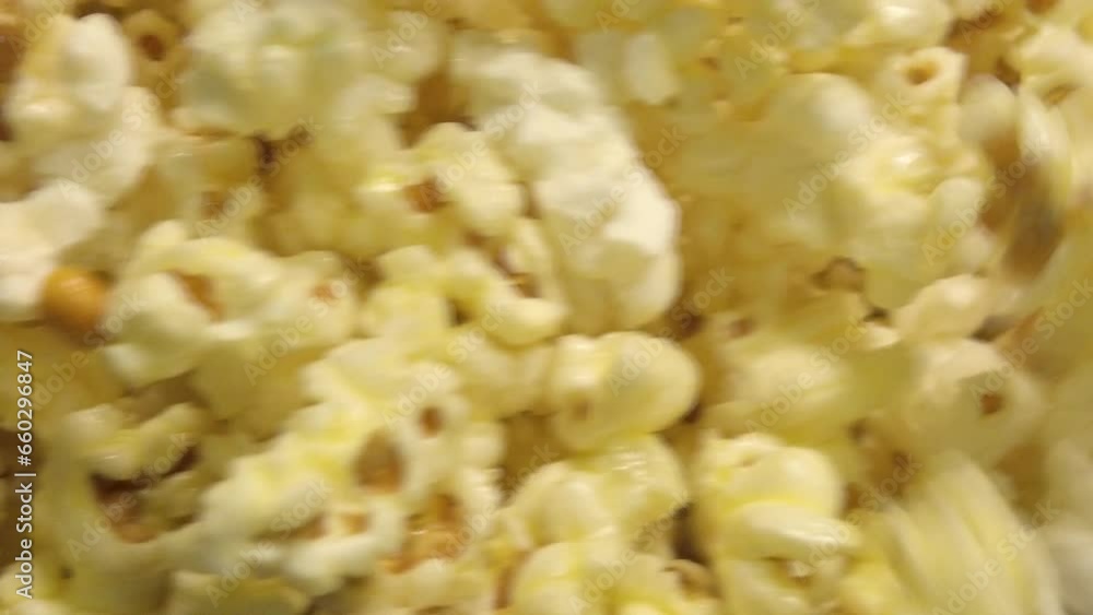 Close-Up shot of Freshly Popped Popcorn Spills Out of the Machine Close-Up shot of Freshly Popped Popcorn Spills Out of the Machine