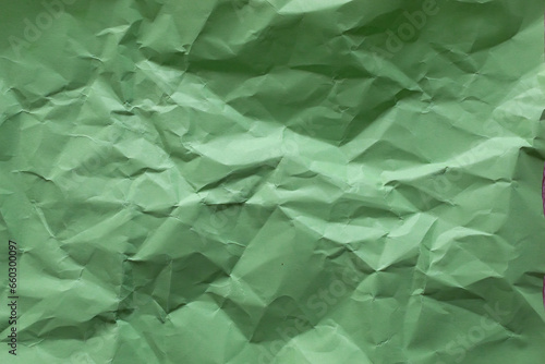 Crumpled green paper as background.
