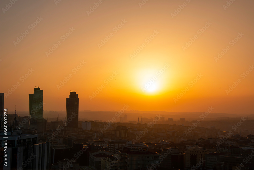 Obraz premium Istanbul cityscape with the reflection of the yellow color of the sunset on the skyscrapers.
