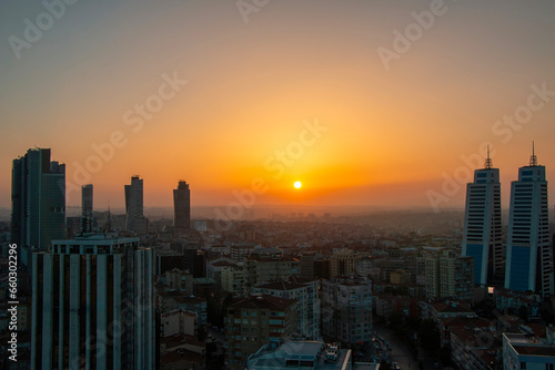 Istanbul cityscape with the reflection of the yellow color of the sunset on the skyscrapers.