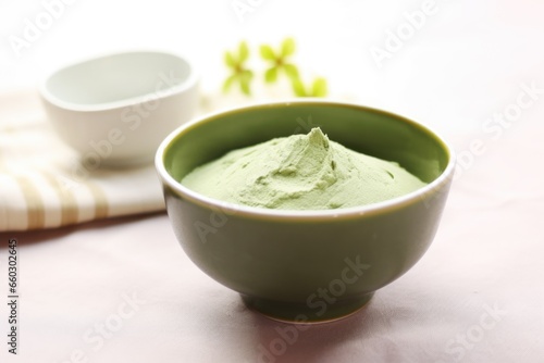 avocado and avocado-based face mask in a ceramic bowl